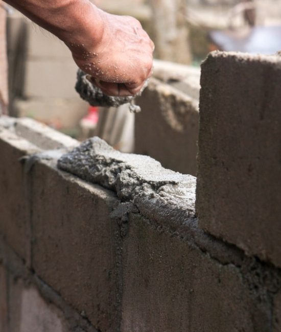 A,Bricklayer,Who,Is,Arranging,Bricks,For,Building,A,House